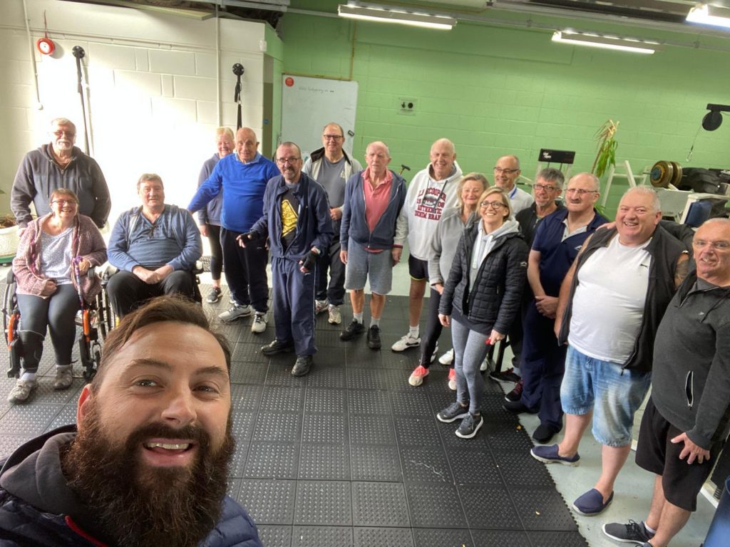 Pete and Brydie with a group in the gym